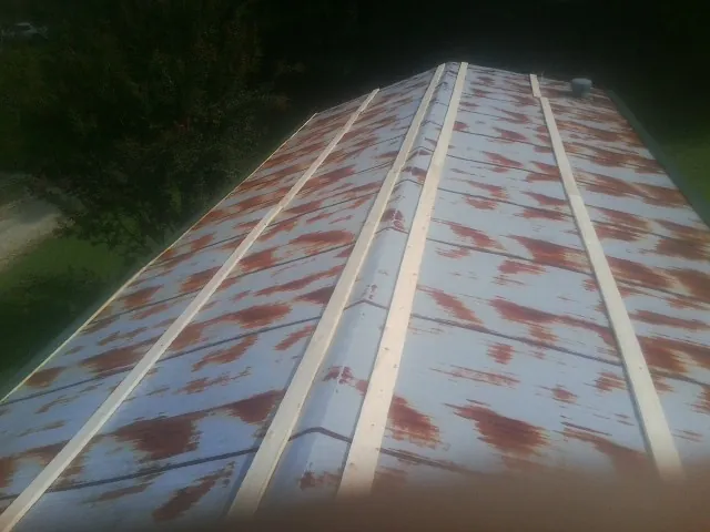 Rusted metal roof panels with new wood purlins before replacement — Storm Damage Roof Repair in Rapelje by Roofing Brothers